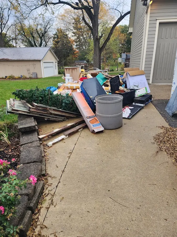 Dumpster being loaded with debris for Commercial Dumpster Rental in New Providence